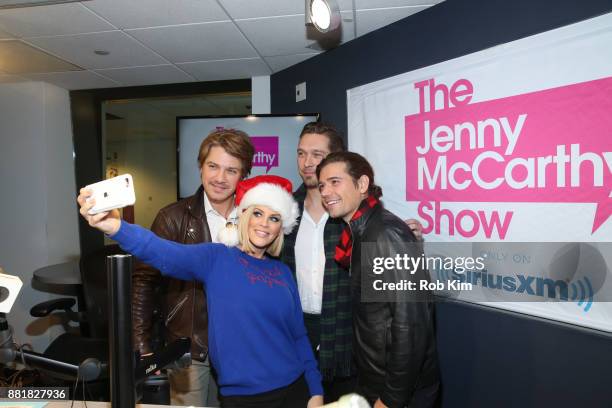 Jenny McCarthy poses with the band Hanson, Taylor Hanson, Zac Hanson and Isaac Hanson during a visit to SiriusXM Studios on November 29, 2017 in New...