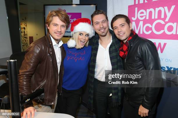 Jenny McCarthy poses with the band Hanson, Taylor Hanson, Zac Hanson and Isaac Hanson during a visit to SiriusXM Studios on November 29, 2017 in New...
