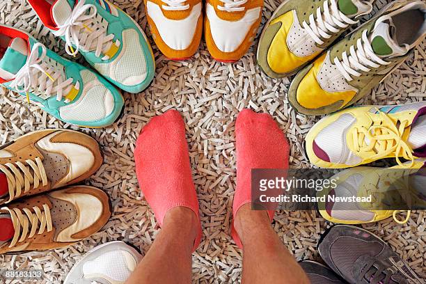 various colored sneakers  - zapatilla fotografías e imágenes de stock