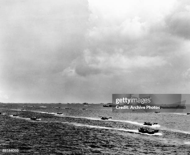 American landing craft carry troops to the beaches of Saipan Island on the first day of the Battle of Saipan in the Northern Mariana Islands, 15th...