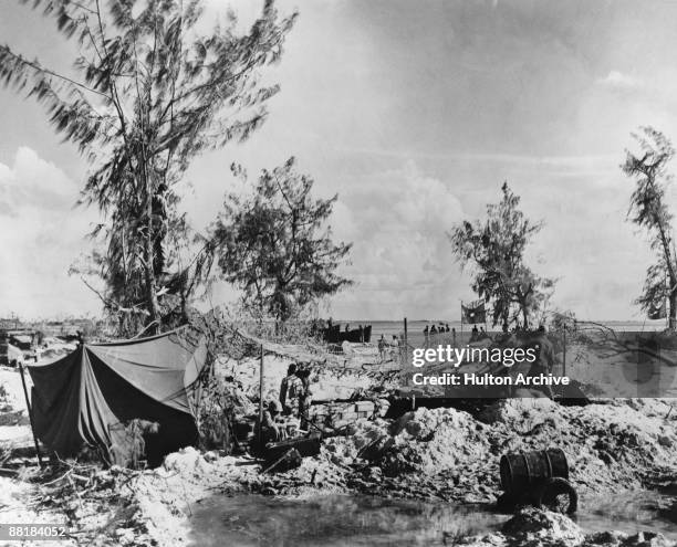 An American Marine gun crew on a beach on Saipan Island during the Battle of Saipan in the Northern Mariana Islands, 25th June 1944.