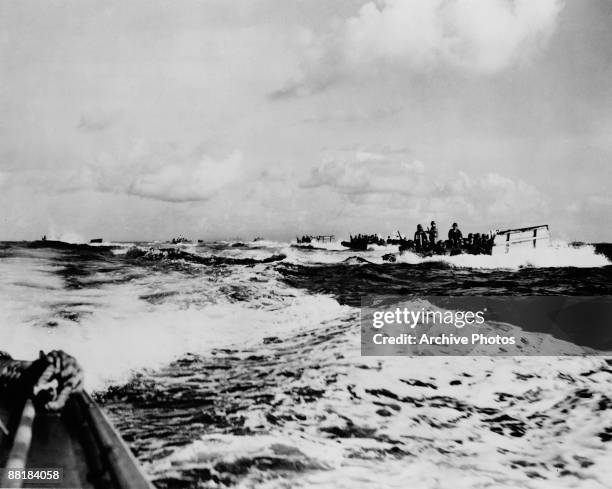 American landing craft carry troops to the beaches of Saipan Island on the first day of the Battle of Saipan in the Northern Mariana Islands, 15th...