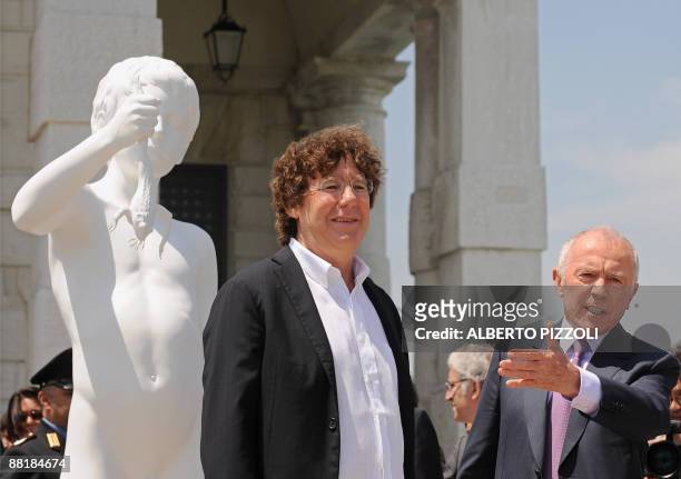 French businessman Francois Pinault and US artist Charles Ray pose near "The Boy with the frog" by Charles Ray in front of Punta della Dogana in...
