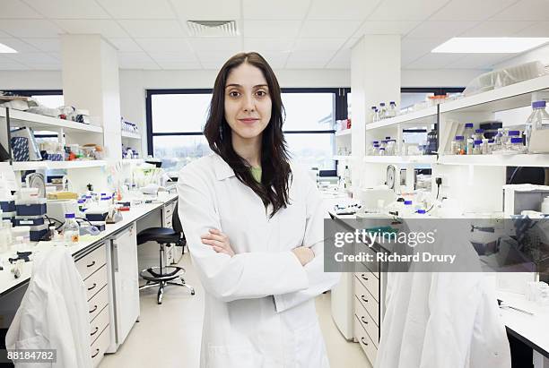 scientist in bioscience laboratory - scientist standing next to table stock-fotos und bilder