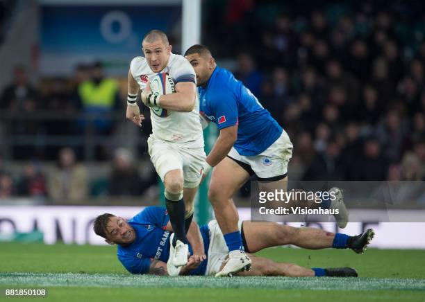 Mike Brown of England escapes the tackle of Jack Lam of Samoa during the Old Mutual Wealth Series autumn international match between England and...