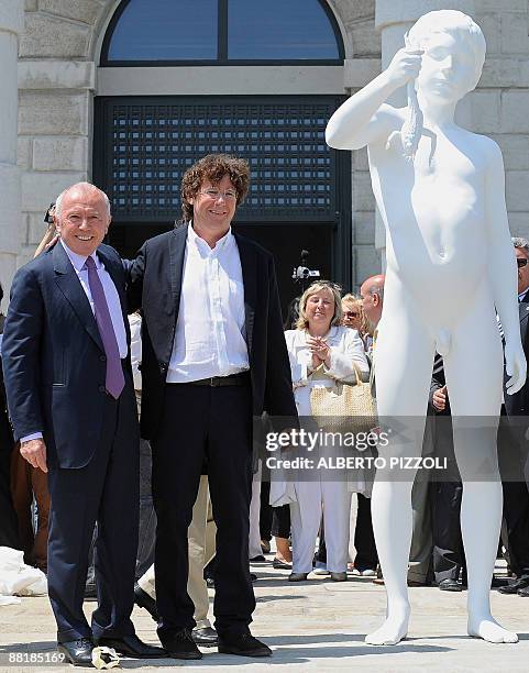 French businessman Francois Pinault and US artist Charles Ray pose near "The Boy with the frog" by Charles Ray in front of the Punta della Dogana in...