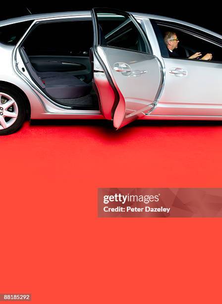 chauffeur with stretched limo on red carpet. - red carpet limo stock pictures, royalty-free photos & images