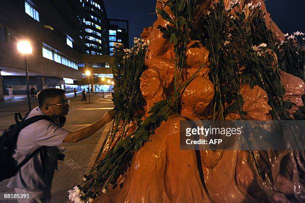 Flowers are placed on the The Pillar of Shame - a statue to mark the Beijing Tiananmen crackdown, in Hong Kong on June 3, 2009. June 4, 2009 is the...