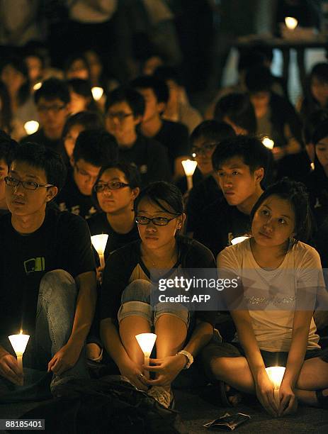 Students from the University of Hong Kong hold a candlelight vigil next to the The Pillar of Shame - a statue to mark the Beijing Tiananmen...