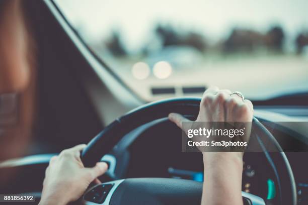 woman driving car or suv - safe driving stock-fotos und bilder