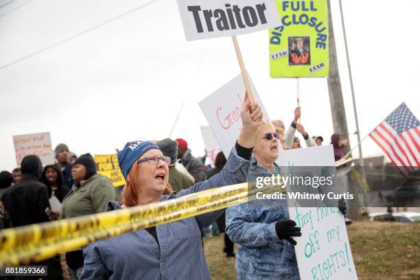 Debbie Pond and other anti-Trump protesters gather outside the St. Charles Convention Center before U.S. President Donald Trump arrives to speak on...