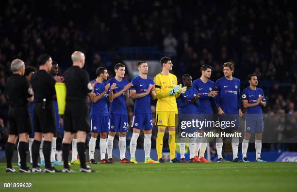 The Chelsea team take part in a minute of appluse in memory for Dermot Drummy during the Premier League match between Chelsea and Swansea City at...