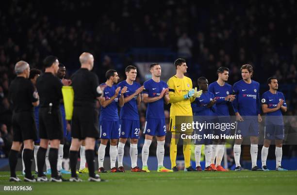 The Chelsea team take part in a minute of appluse in memory for Dermot Drummy during the Premier League match between Chelsea and Swansea City at...