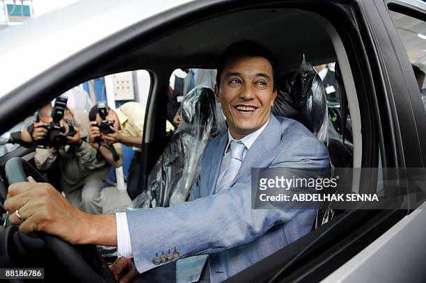 Moroccan minster for industry Ahmed Reda Chami looks on from inside the newly launcehd Dacia Logan-Sandero in Casablanca on June 3, 2009. The Dacia...