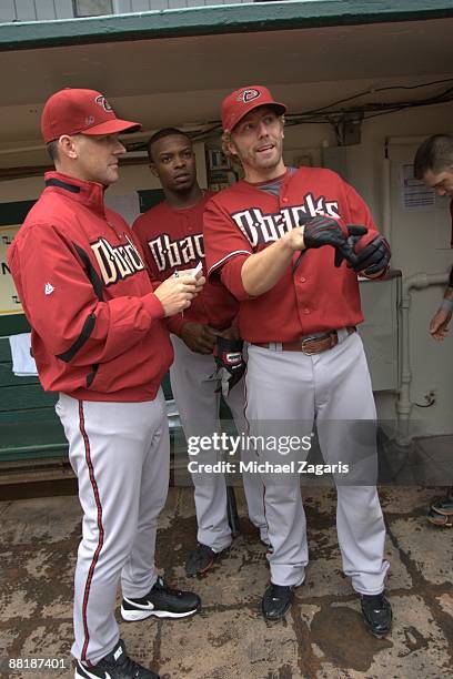 Manager A.J. Hinch of the Arizona Diamondbacks talks with Justin Upton and Mark Reynolds in the dugout prior to the game against the Oakland...