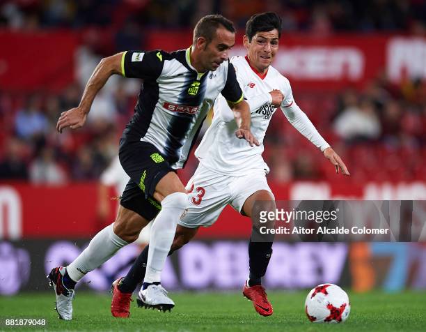 Alberto Aguilar of FC Cartagena being followed by Borja Lasso of Sevilla FC during la Copa del Rey match between Sevilla FC and FC Cartagena at...
