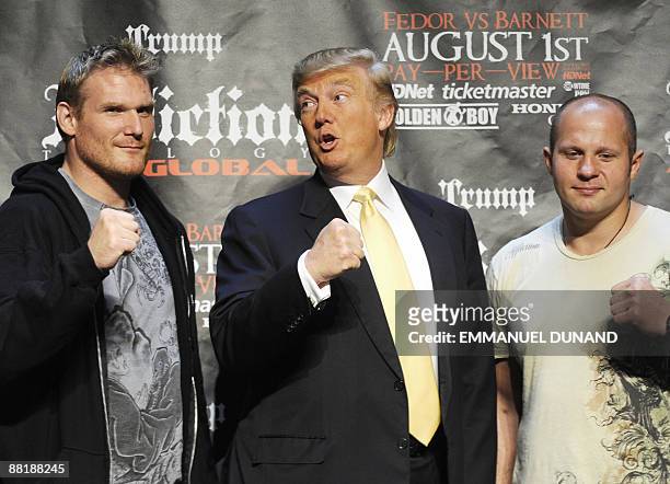 Real estate mogul Donald Trump poses with Mixed Martial Art heavyweight fighters US Josh Barnett and Russia's Fedor Emelianenko in New York on June...