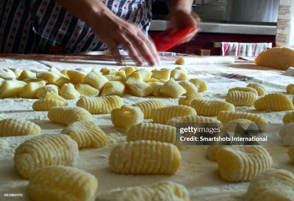 Traditional homemade preparation of fresh, handmade potato gnocchi pasta in Piedmont, Italy
