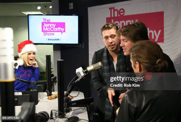 Members of Hanson, L-R Isaac Hanson, Taylor Hanson and Zac Hanson perform live on radio with Jenny McCarthy looking on, during ''The Jenny McCarthy...