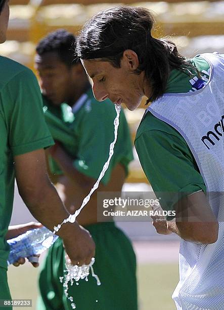 Bolivian footballer Pablo Escobar spits water during a training session on June 3, 2009 at the Hernando Siles stadium in La Paz. Bolivia faces...