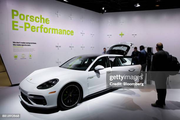 Attendees view the Porsche Automobil Holding SE Panamera Turbo S e-hybrid vehicle is displayed during AutoMobility LA ahead of the Los Angeles Auto...