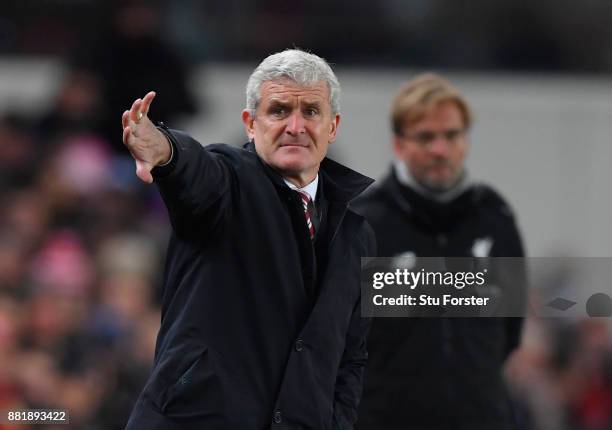 Mark Hughes, Manager of Stoke City gives his team instructions during the Premier League match between Stoke City and Liverpool at Bet365 Stadium on...