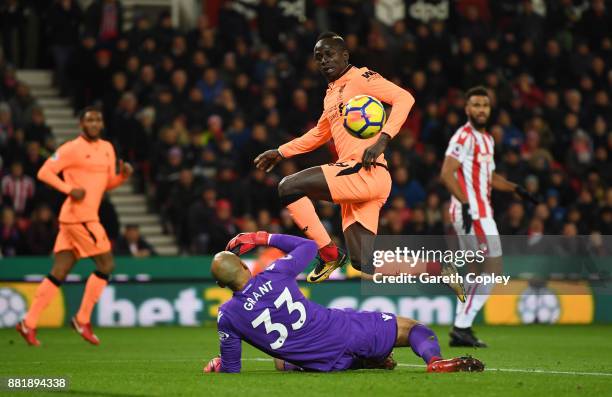 Sadio Mane of Liverpool scores his sides first goal past Lee Grant of Stoke City during the Premier League match between Stoke City and Liverpool at...