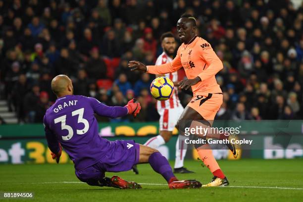 Sadio Mane of Liverpool scores his sides first goal past Lee Grant of Stoke City during the Premier League match between Stoke City and Liverpool at...
