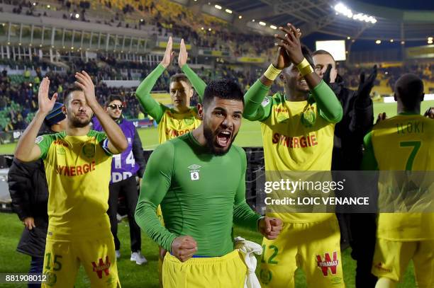 Nantes' Brazilian defender Lucas Lima celebrates with teammates at the end of the French L1 football match Nantes vs Monaco at the La Beaujoire...