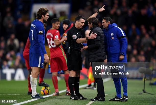 Referee Neil Swarbrick sends Antonio Conte, Manager of Chelsea to the stands during the Premier League match between Chelsea and Swansea City at...