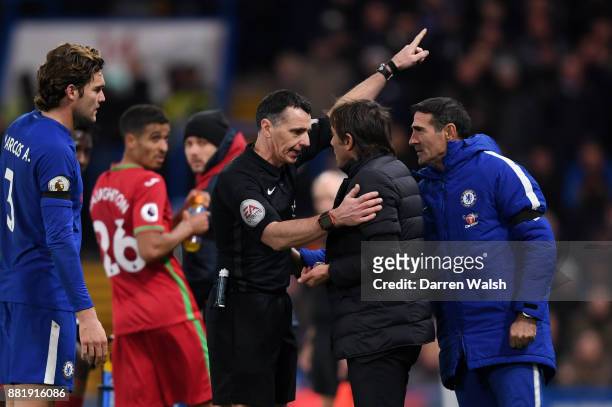 Referee Neil Swarbrick sends Antonio Conte, Manager of Chelsea to the stands during the Premier League match between Chelsea and Swansea City at...