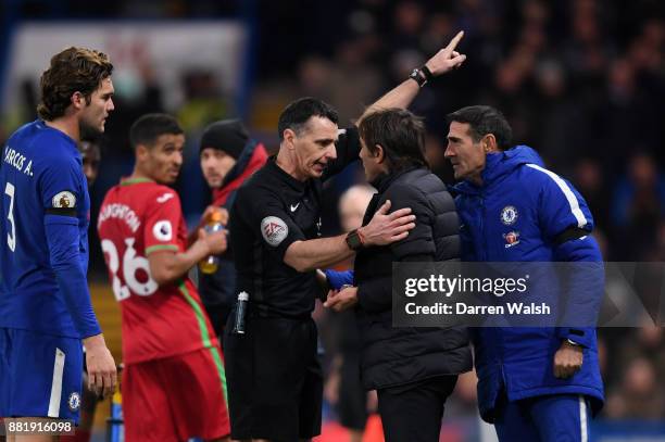 Referee Neil Swarbrick sends Antonio Conte, Manager of Chelsea to the stands during the Premier League match between Chelsea and Swansea City at...