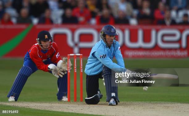 Murray Goodwin of Sussex hits out as Adam Wheater of Essex watches on during The Twenty20 Cup match between Essex Eagles and Sussex Sharks at The...