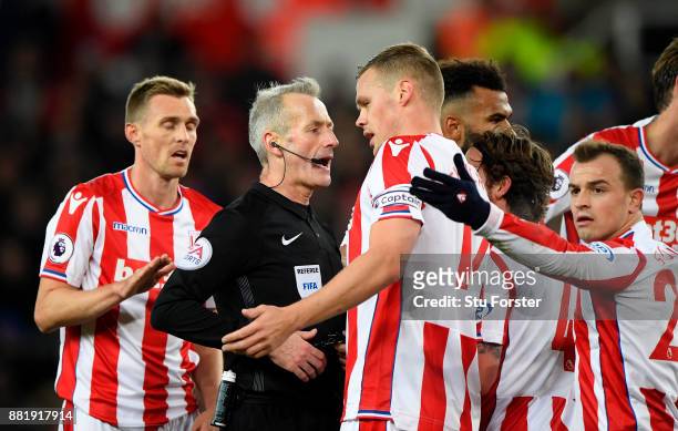 Ryan Shawcross of Stoke City argues with referee Martin Atkinson during the Premier League match between Stoke City and Liverpool at Bet365 Stadium...