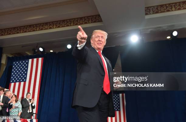 President Donald Trump points before speaking about taxes at the St. Charles, Missouri, Convention Center on November 29, 2017.