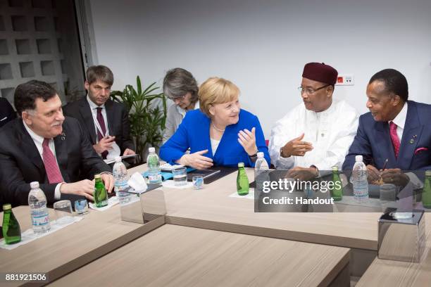 In this handout photo provided by the German Government Press Office Chancellor Angela Merkel, President of Niger Issoufou Mahamadou , Libyan...