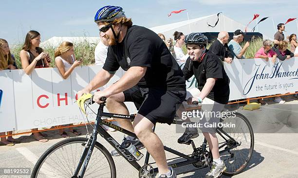 New England Patriot Matt Light and his Best Buddy ride a relay race during the 2009 Audi Best Buddies Challenge: Hyannis Port on May 30, 2009 in...