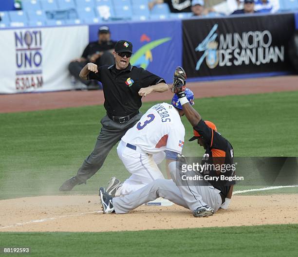 Yurendell DeCaster tags out Willy Taveras during game one of Pool D, between the Dominican Republic and the Netherlands during the the first round of...