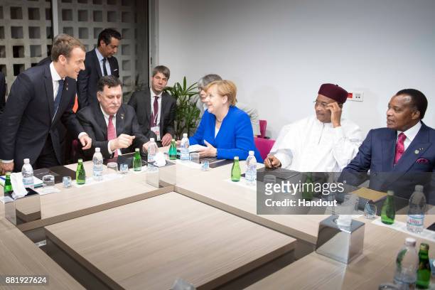 In this handout photo provided by the German Government Press Office Chancellor Angela Merkel and French President Emmanuel Macron as well as Niger's...