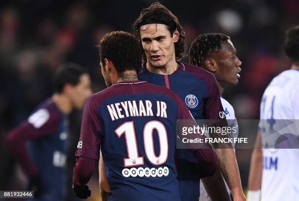 Paris Saint-Germain's Uruguayan forward Edinson Cavani speaks with Paris Saint-Germain's Brazilian forward Neymar prior to kick a penalty during the...