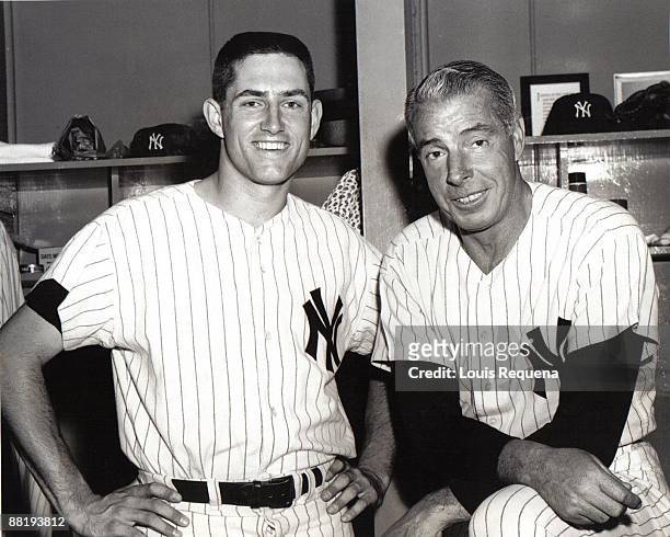 Hall of Famer Joe DiMaggio poses with Fritz Peterson of the New York Yankees in the locker room during Old Timers Day on August 19, 1967 at Yankee...