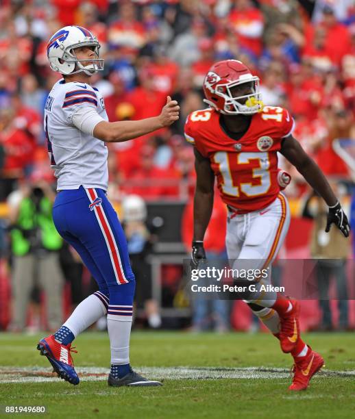 Kicker Stephen Hauschka of the Buffalo Bills watches after kicking a field goal, with player De'Anthony Thomas of the Kansas City Chiefs during the...