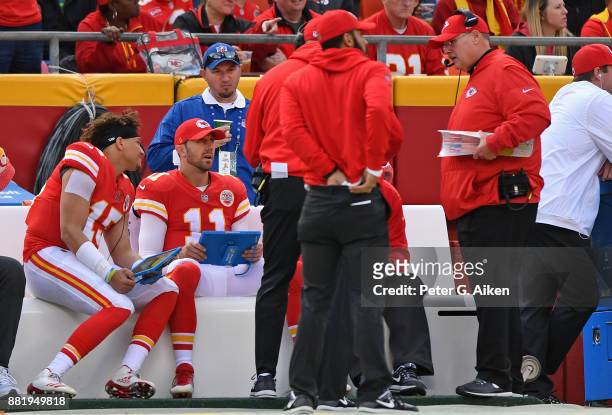 Quarterbacks Alex Smith, Patrick Mahomes of the Kansas City Chiefs talk over offensive plays with head coach Andy Reid against the Buffalo Bills...
