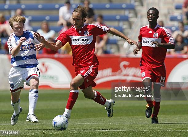 Justin Mapp and Patrick Nyarko of the Chicago Fire move the ball up the field as Dax McCarty of FC Dallas defends during the first half at Toyota...