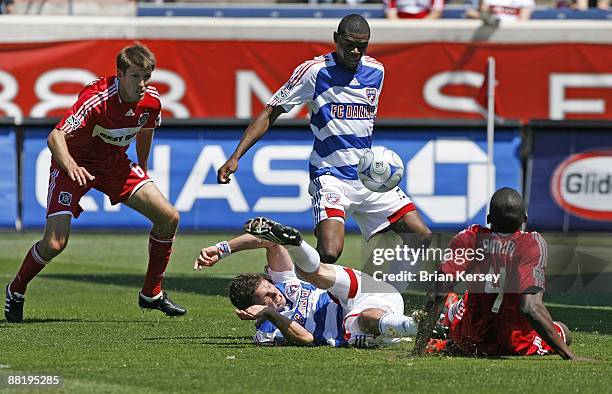 Brandon Prideaux and Bakary Soumare of the Chicago Fire battle for the ball against Drew Moor and Anthony Wallace of FC Dallas during the first half...