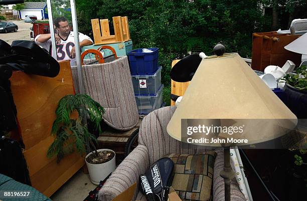 An eviction team member looks over household belongings removed from a home during foreclosure proceedings June 3, 2009 in Lafayette, Colorado. The...