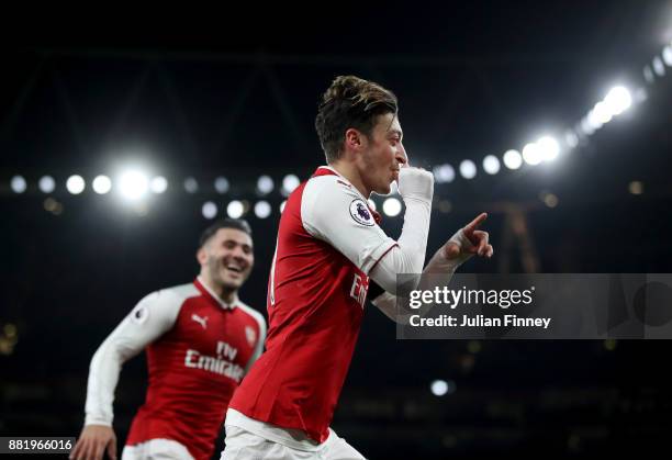 Mesut Ozil of Arsenal celebrates after scoring his sides fourth goal with Sead Kolasinac of Arsenal during the Premier League match between Arsenal...