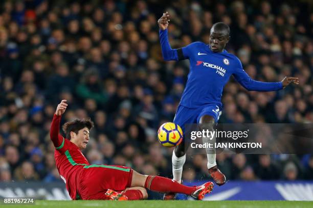 Chelsea's French midfielder N'Golo Kante is tackled by Swansea City's South Korean midfielder Ki Sung-Yueng during the English Premier League...