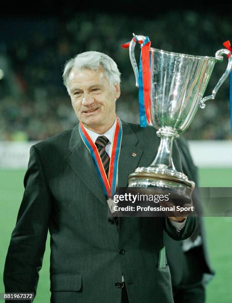 Barcelona manager Bobby Robson celebrates with the trophy after his team won the European Cup Winners' Cup against Paris Saint-Germain at the Stadion...