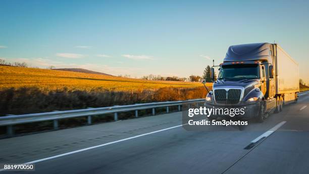 semi truck 18 wheeler on highway copy space - motor vehicle stock-fotos und bilder